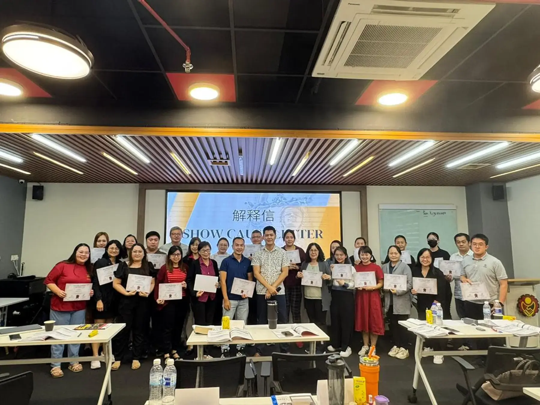 A group photo of participants with certificates after a BBH course
